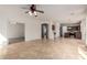 Open-concept living room featuring tile floors and a doorway to the kitchen at 10313 W Windsor Ave, Avondale, AZ 85392