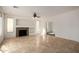 Spacious living room with tile flooring, a ceiling fan, and a stone fireplace at 10313 W Windsor Ave, Avondale, AZ 85392