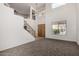 Bright living room boasts soaring ceilings, a staircase, and ample natural light at 10313 W Windsor Ave, Avondale, AZ 85392