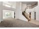 Bright living room boasts soaring ceilings, a staircase, and ample natural light at 10313 W Windsor Ave, Avondale, AZ 85392