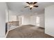 Open carpeted loft space with railings and open doorways leading to rooms with carpet at 10313 W Windsor Ave, Avondale, AZ 85392
