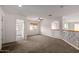 Open carpeted loft area with archway, railing, and access to other rooms with carpet at 10313 W Windsor Ave, Avondale, AZ 85392