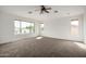 Bright loft space with carpet, a ceiling fan, and windows offering natural light at 10313 W Windsor Ave, Avondale, AZ 85392