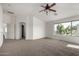 Large loft with carpet, window views, and hallways leading to other rooms at 10313 W Windsor Ave, Avondale, AZ 85392
