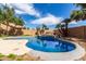 Beautiful in-ground pool with water feature, palm trees and privacy fence for peaceful relaxation at 10313 W Windsor Ave, Avondale, AZ 85392