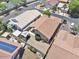 Aerial view of a backyard featuring a covered patio and desert landscaping, offering a private retreat at 11550 W Mule Deer Ct, Surprise, AZ 85378