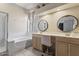 Well-lit bathroom with a double vanity, a separate shower and tub, and neutral finishes, creating a spa-like atmosphere at 11550 W Mule Deer Ct, Surprise, AZ 85378
