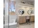 Bright bathroom featuring a double vanity, a large tub, and a separate shower, perfect for a relaxing experience at 11550 W Mule Deer Ct, Surprise, AZ 85378
