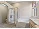Bright bathroom with a separate shower and tub, featuring neutral tones and ample space at 11550 W Mule Deer Ct, Surprise, AZ 85378