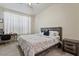 Bedroom with a neutral color scheme, a desk area, and a large window, perfect for sleep and study at 11550 W Mule Deer Ct, Surprise, AZ 85378
