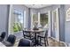 Bright dining area features a round table with seating, large windows, and light-colored walls, creating an inviting atmosphere at 11550 W Mule Deer Ct, Surprise, AZ 85378