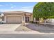 Inviting single-story home with desert landscaping, tiled roof, and attached two-car garage at 11550 W Mule Deer Ct, Surprise, AZ 85378