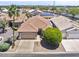 Charming single-story home featuring a tile roof, two-car garage, and mature landscaping at 11550 W Mule Deer Ct, Surprise, AZ 85378