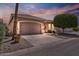 Exterior view of a charming single-story home featuring a well-manicured lawn and a two-car garage at 11550 W Mule Deer Ct, Surprise, AZ 85378