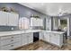 Functional kitchen featuring white cabinetry, updated appliances, and spacious countertops at 11550 W Mule Deer Ct, Surprise, AZ 85378