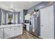 Bright kitchen with white cabinets, stainless appliances, desk area and dining area beyond at 11550 W Mule Deer Ct, Surprise, AZ 85378