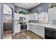 Well-appointed kitchen with white cabinets, stainless steel appliances, and modern finishes at 11550 W Mule Deer Ct, Surprise, AZ 85378