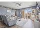 Open living area featuring patio access, stylish furnishings, and plenty of natural light at 11550 W Mule Deer Ct, Surprise, AZ 85378