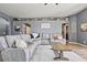 Cozy living area with a comfortable sectional sofa, decorative shelving, and modern decor at 11550 W Mule Deer Ct, Surprise, AZ 85378