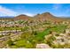 Picturesque aerial showcases the community, golf course, and the scenic mountain backdrop at 13614 N 12Th Way, Phoenix, AZ 85022