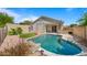 Inviting backyard features a sparkling pool with rock accents and lush landscaping at 13614 N 12Th Way, Phoenix, AZ 85022