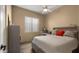 Cozy bedroom with ceiling fan, plush bedding, and a neutral palette, offering a relaxing retreat at 13614 N 12Th Way, Phoenix, AZ 85022