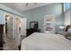 Serene bedroom featuring wood-look floors, neutral tones, and an ensuite bathroom providing a peaceful retreat at 13614 N 12Th Way, Phoenix, AZ 85022