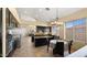 The kitchen is large and has an island with a breakfast table, dark cabinets, and tile floors at 13614 N 12Th Way, Phoenix, AZ 85022