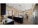 Eat-in kitchen featuring dark cabinets, granite counters, an island, and stainless steel appliances at 13614 N 12Th Way, Phoenix, AZ 85022
