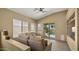 Cozy living space with large windows, a comfortable couch, and access to the backyard pool at 13614 N 12Th Way, Phoenix, AZ 85022