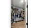 Organized walk-in closet with ample shelving, hanging space, and shoe storage for a tidy and efficient storage solution at 13614 N 12Th Way, Phoenix, AZ 85022