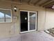 View of back porch with brick wall, light fixture, and sliding glass door leading into home at 1404 S Spencer --, Mesa, AZ 85204