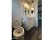 This bathroom includes a sink with white cabinet and a toilet at 1404 S Spencer --, Mesa, AZ 85204