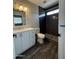 Bathroom with a toilet, sink and shower with black tiling at 1404 S Spencer --, Mesa, AZ 85204