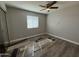 Bedroom with ceiling fan and a window needing new floor installation at 1404 S Spencer --, Mesa, AZ 85204