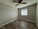 Bedroom with ceiling fan and newly installed floor at 1404 S Spencer --, Mesa, AZ 85204