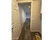 Hallway featuring modern wood-look flooring, light gray walls, and white trim, creating a clean and inviting transition space at 1404 S Spencer --, Mesa, AZ 85204
