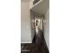 Hallway featuring modern wood-look flooring, light gray walls, and white trim, creating a clean and inviting transition space at 1404 S Spencer --, Mesa, AZ 85204