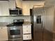 The kitchen features stainless steel appliances and white cabinets with granite countertops, adding a modern touch to the home at 1404 S Spencer --, Mesa, AZ 85204