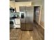 The kitchen features stainless steel appliances and white cabinets with granite countertops, complemented by wood-style flooring at 1404 S Spencer --, Mesa, AZ 85204