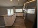Bright kitchen with a center island, granite countertops, and stainless steel refrigerator at 1404 S Spencer --, Mesa, AZ 85204