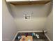 This laundry room has white cabinets, neutral walls, and wood-look floors, offering a clean and functional space at 1404 S Spencer --, Mesa, AZ 85204