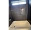 This shower has dark tile and a light shining from a window at 1404 S Spencer --, Mesa, AZ 85204