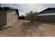 Spacious side yard showcases dirt landscaping and mature tree between homes at 1404 S Spencer --, Mesa, AZ 85204