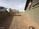 Spacious side yard showcases dirt landscaping and mature tree between homes at 1404 S Spencer --, Mesa, AZ 85204