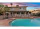 Fenced in backyard with pool, diving board, patio and desert landscaping at 1411 W Mendoza Ave, Mesa, AZ 85202