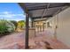 Covered patio featuring outdoor kitchen, desert landscaping, and a view of the swimming pool at 1411 W Mendoza Ave, Mesa, AZ 85202