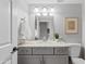 Updated bathroom with granite countertops, stylish vanity, modern fixtures, and decorative artwork at 1411 W Mendoza Ave, Mesa, AZ 85202