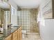 Updated bathroom featuring double sinks with granite countertop, and a glass block walk-in shower at 1411 W Mendoza Ave, Mesa, AZ 85202