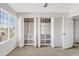 Bedroom featuring carpet and an open closet with shelving; a window offers ample natural light at 1411 W Mendoza Ave, Mesa, AZ 85202